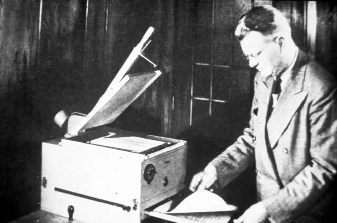 The inventor standing beside the first xerox
